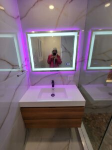 bathroom renovations company toronto An oak vanity with a pendant light, complemented by a modern LED mirror, adds warmth and sophistication Thornhill