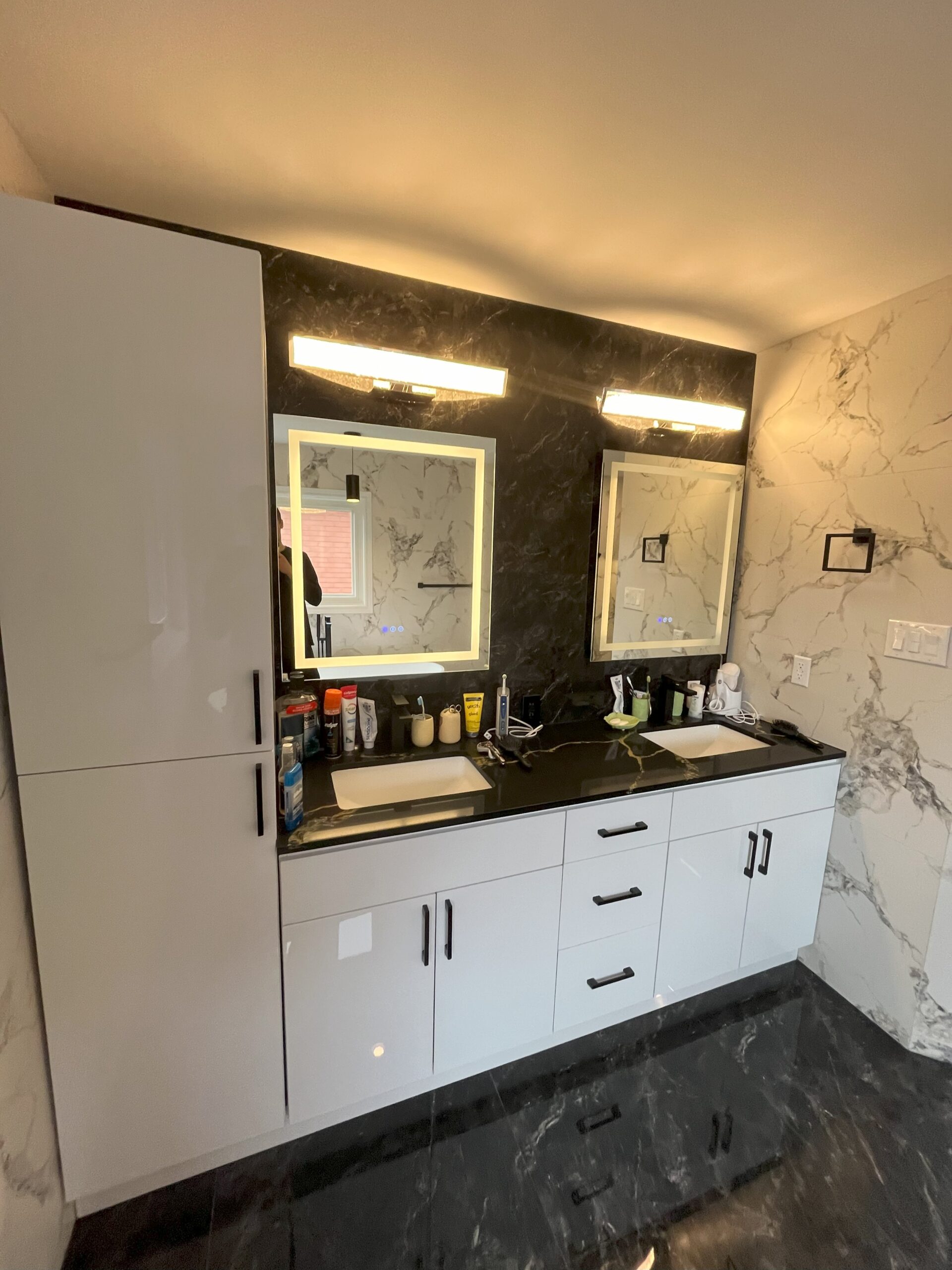 Double vanity in a renovated Markham bathroom with marble tile