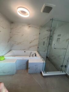 fabricated and installed one of a kind L shaped frameless glass shower enclosure complete with hinged glass door Thornhill