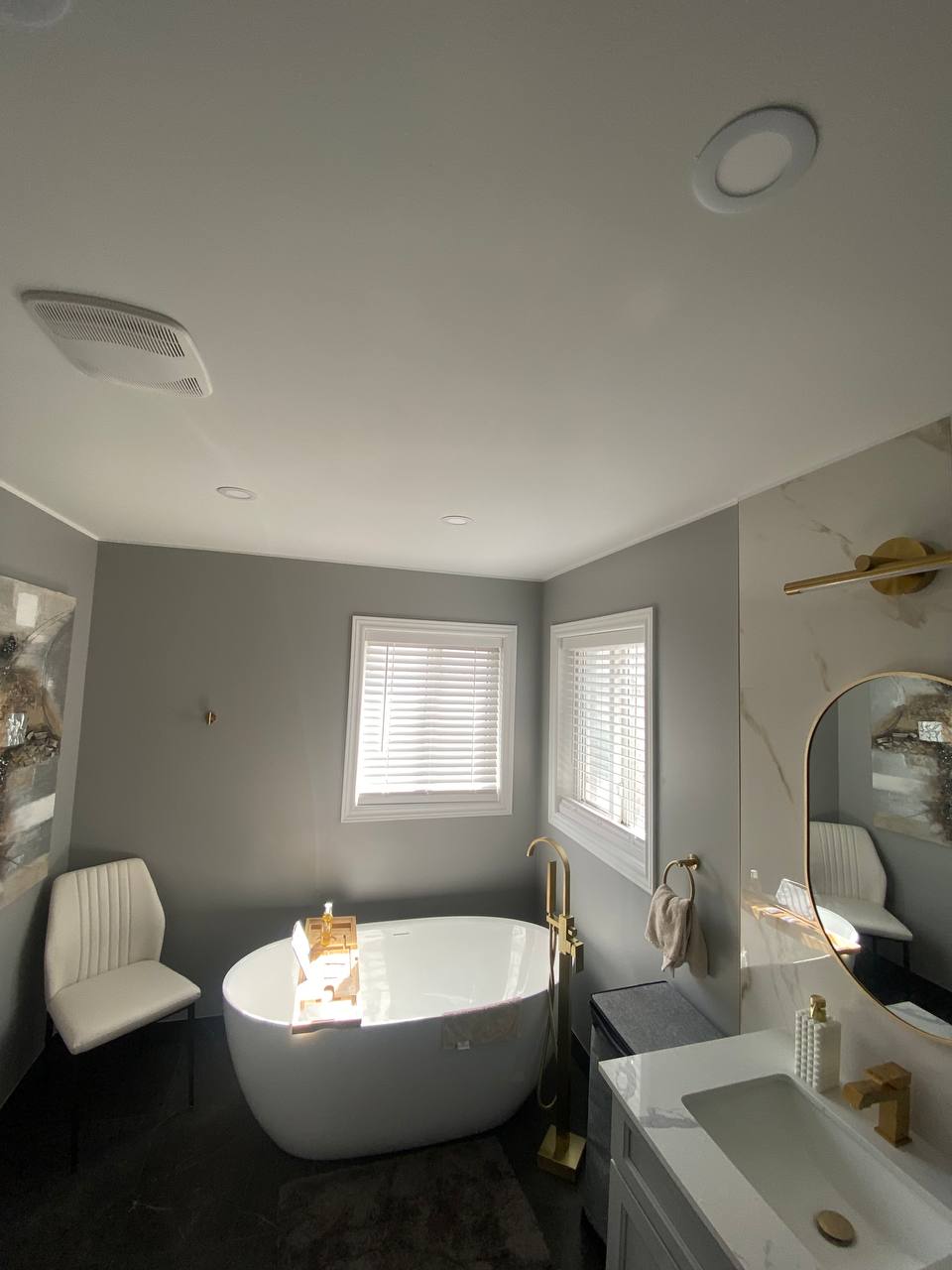modern bathroom with white freestanding tub gray walls and white blinds