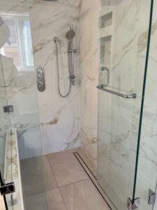 walk in shower with custom enclosure four intricately shaped glass panels each with numerous connection points Thornhill