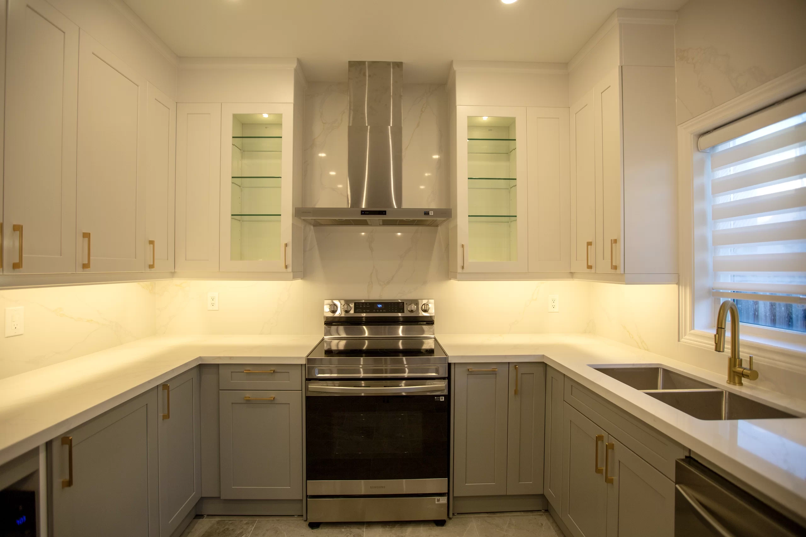 U-shaped kitchen remodel with quartz and brass Toronto project