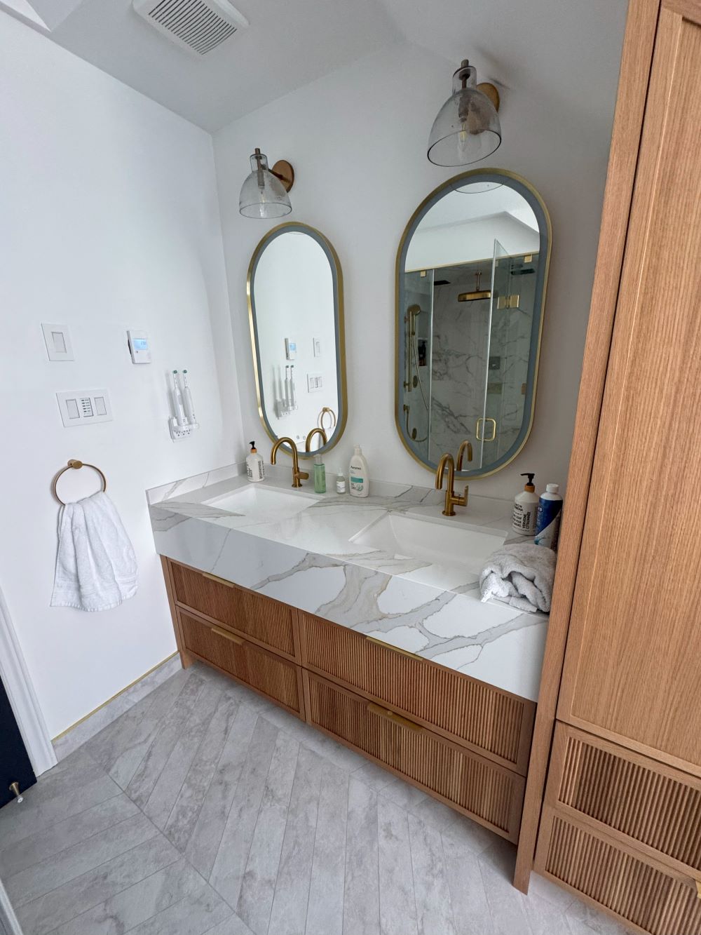 Custom floating oak vanity with dual sinks and marble countertop Barrie