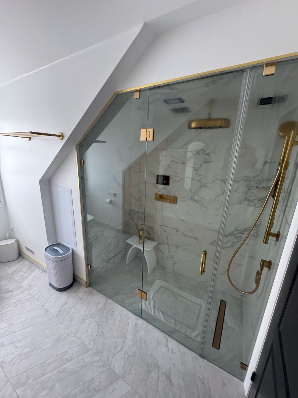 Bathtub to shower conversion. Glass steam shower enclosure with matte brass fixtures