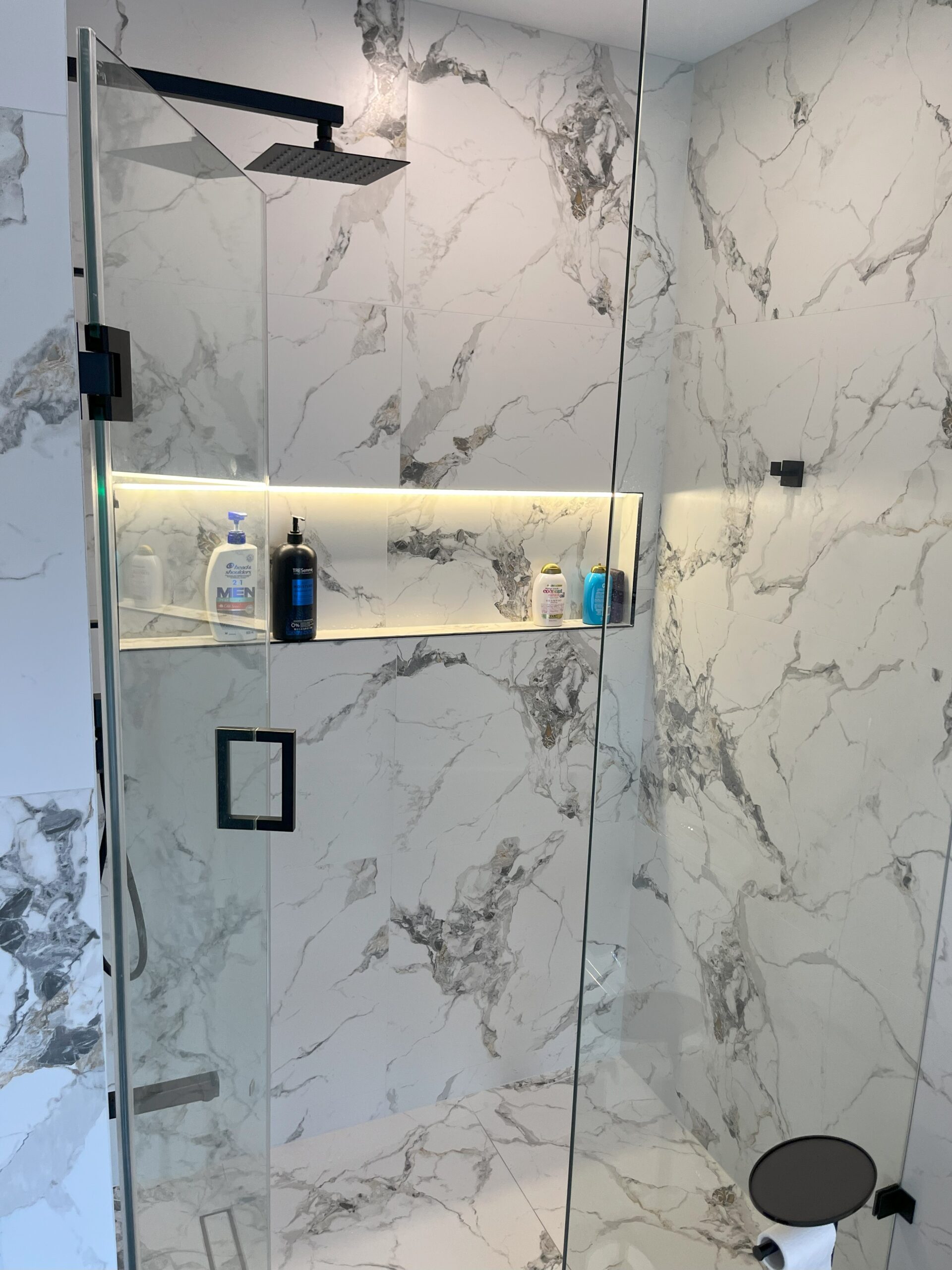 transform bathtub to shower, bathroom glass shower, black fixtures, marble walls Barrie