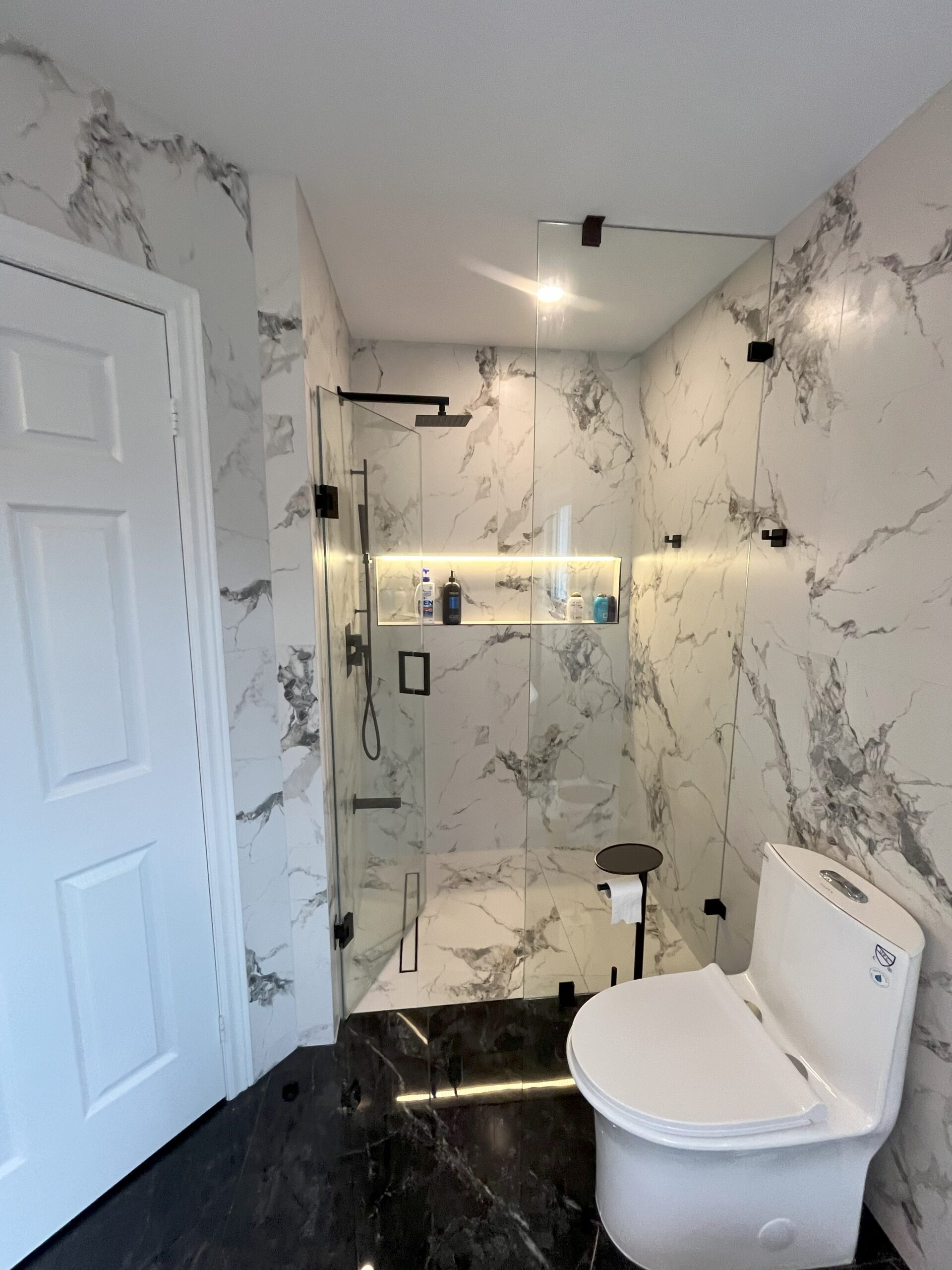 shower to bathtub conversion, bathroom renovation with marble tile and glass shower Barrie