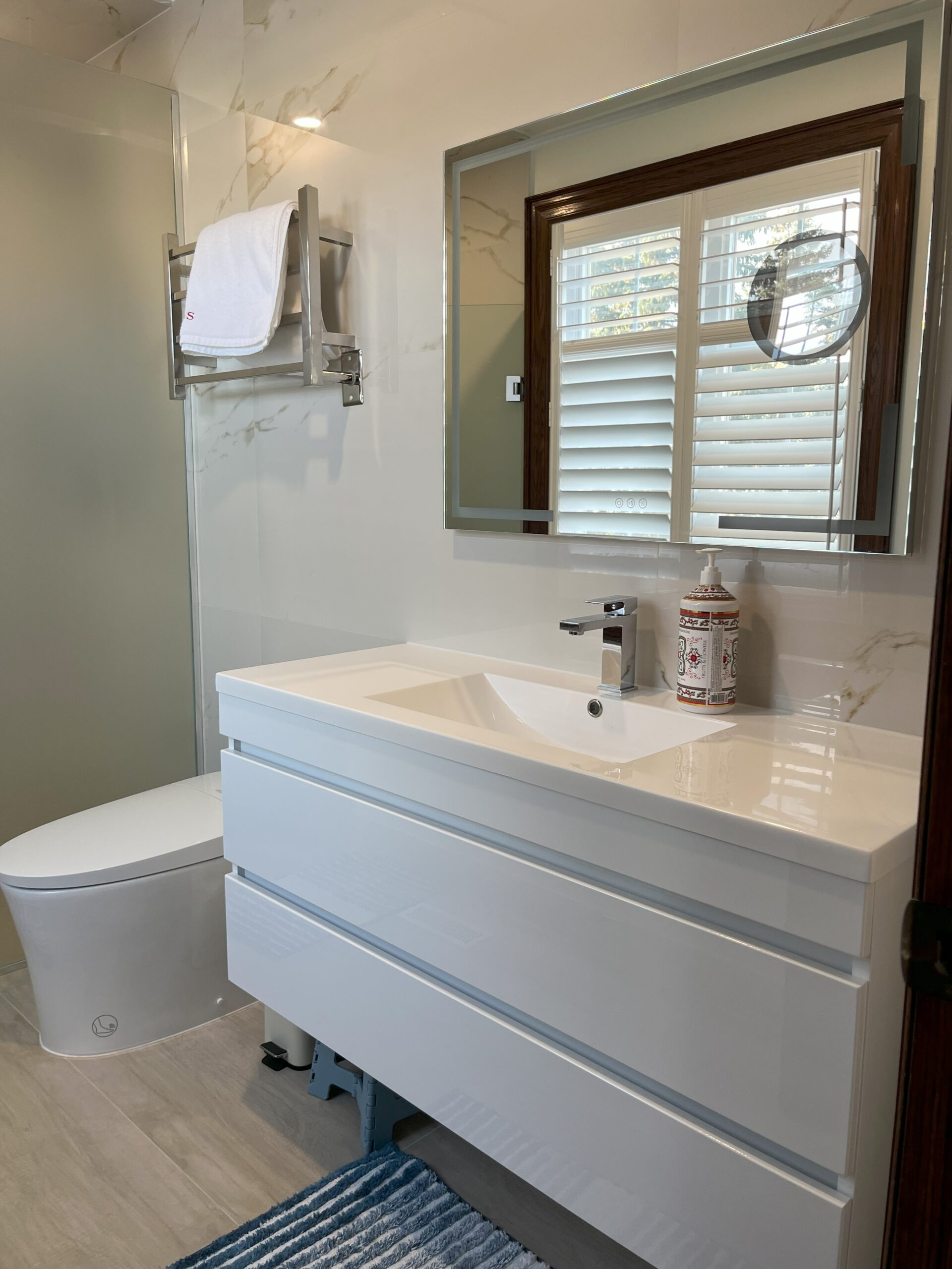 insatallation curbless glass shower custom niche fly vanity smart toilet electric heated towel rail underfloor heating 2 bathworks Barrie