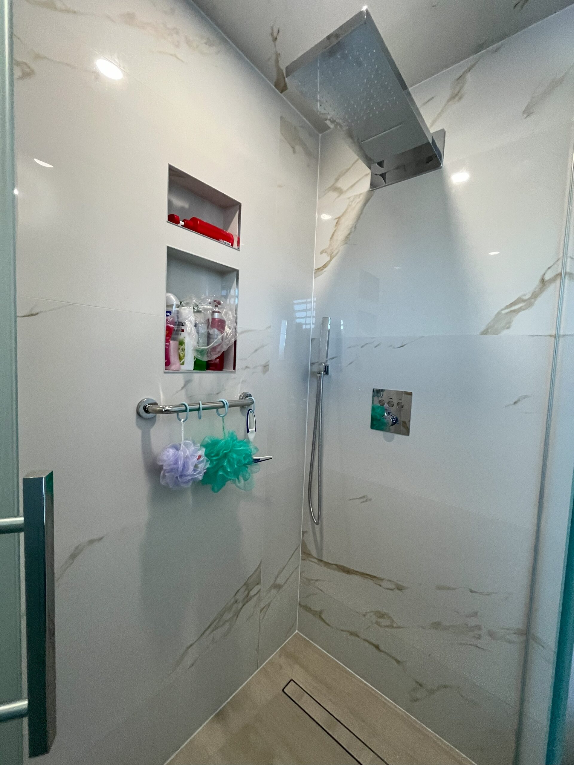 tub to shower renovation, insatallation curbless glass shower custom niche fly vanity smart toilet electric heated towel rail underfloor heating bathroom renovators Barrie