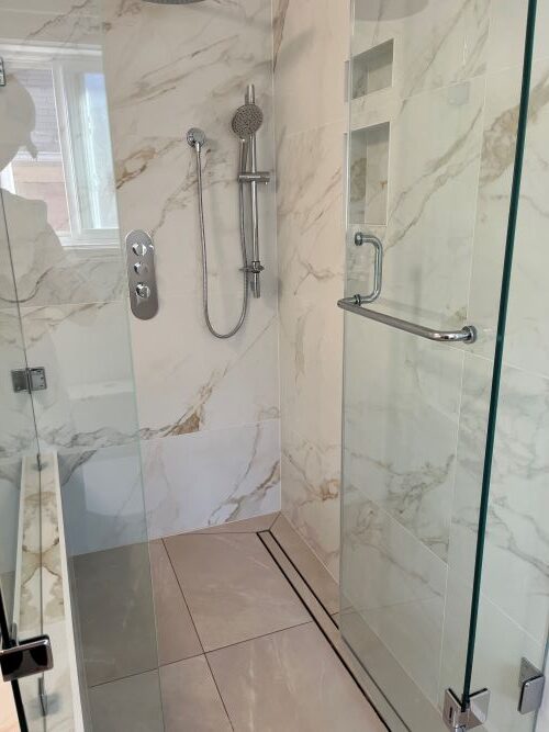 walk in shower with custom enclosure four intricately shaped glass panels each with numerous connection points Barrie