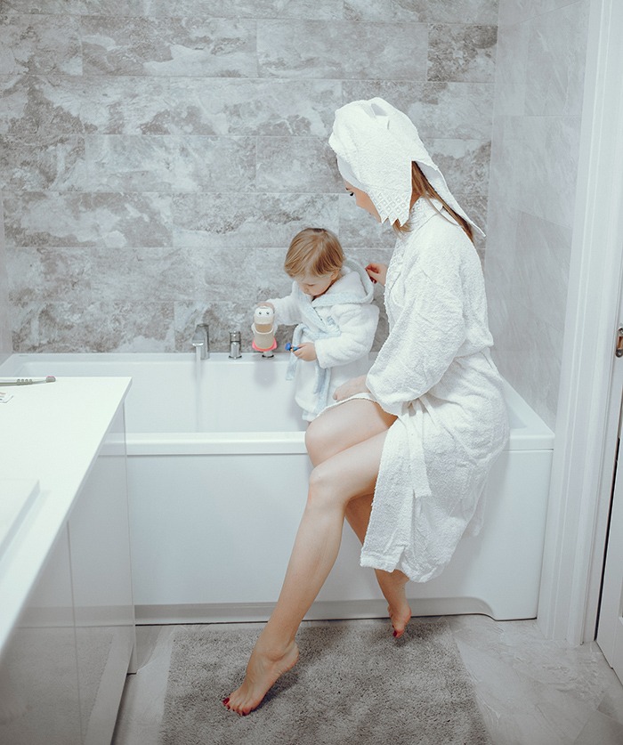 Mother with little son in a bathroom