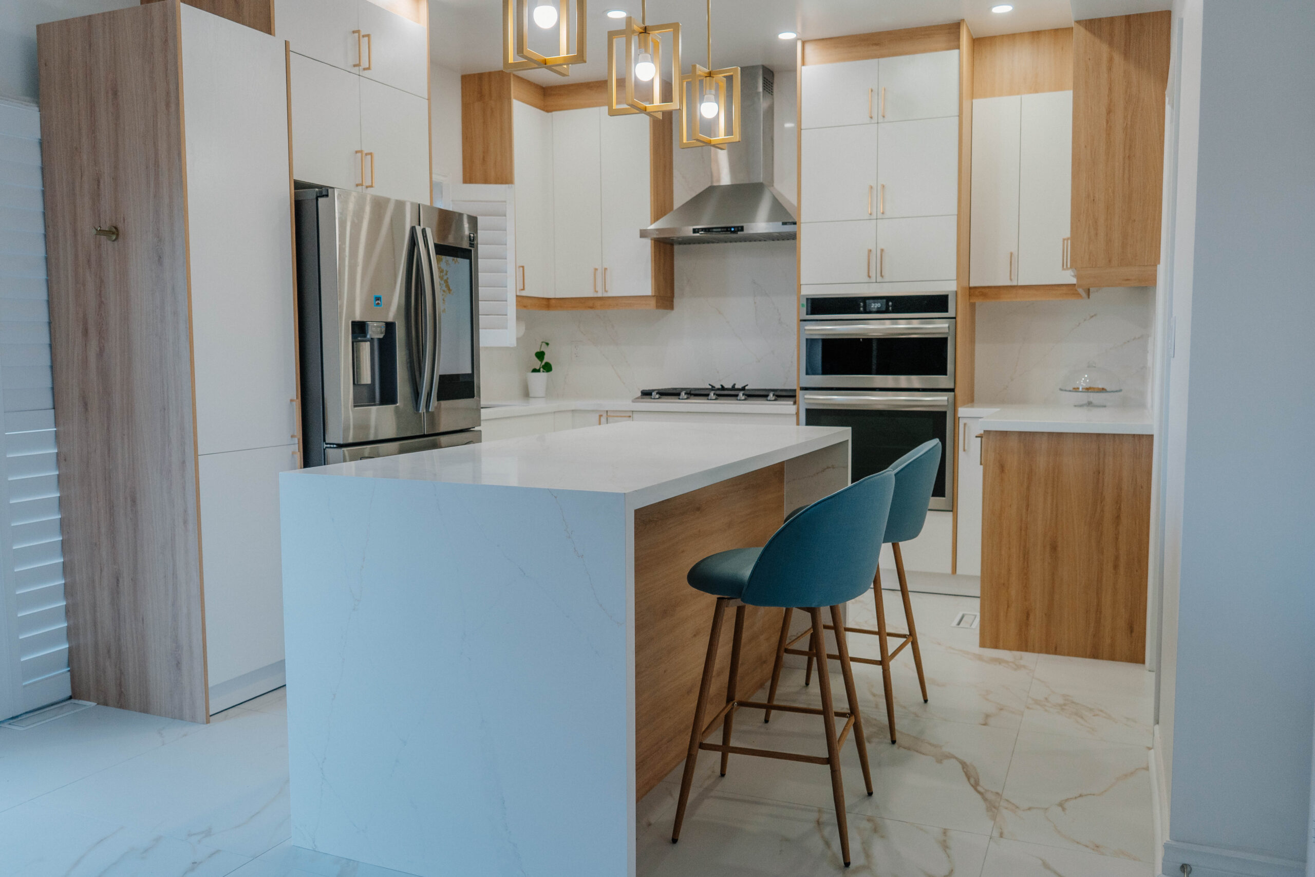 A bright and airy Deluxe Style kitchen in Thornhill featuring a seamless Calacatta Gold porcelain floor and a two tone design with Matte White and Rustic Oak cabinets Pickering