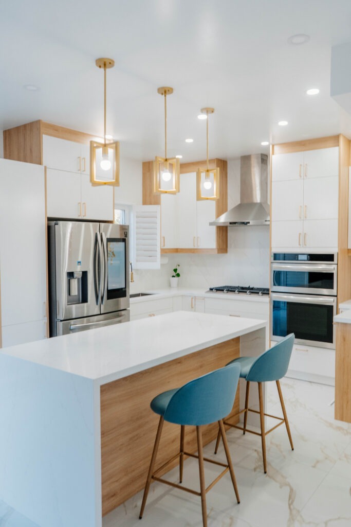 A bright, sweeping overview of the entire Deluxe Style kitchen renovation in Thornhill, highlighting the open concept layout and luxurious finishes