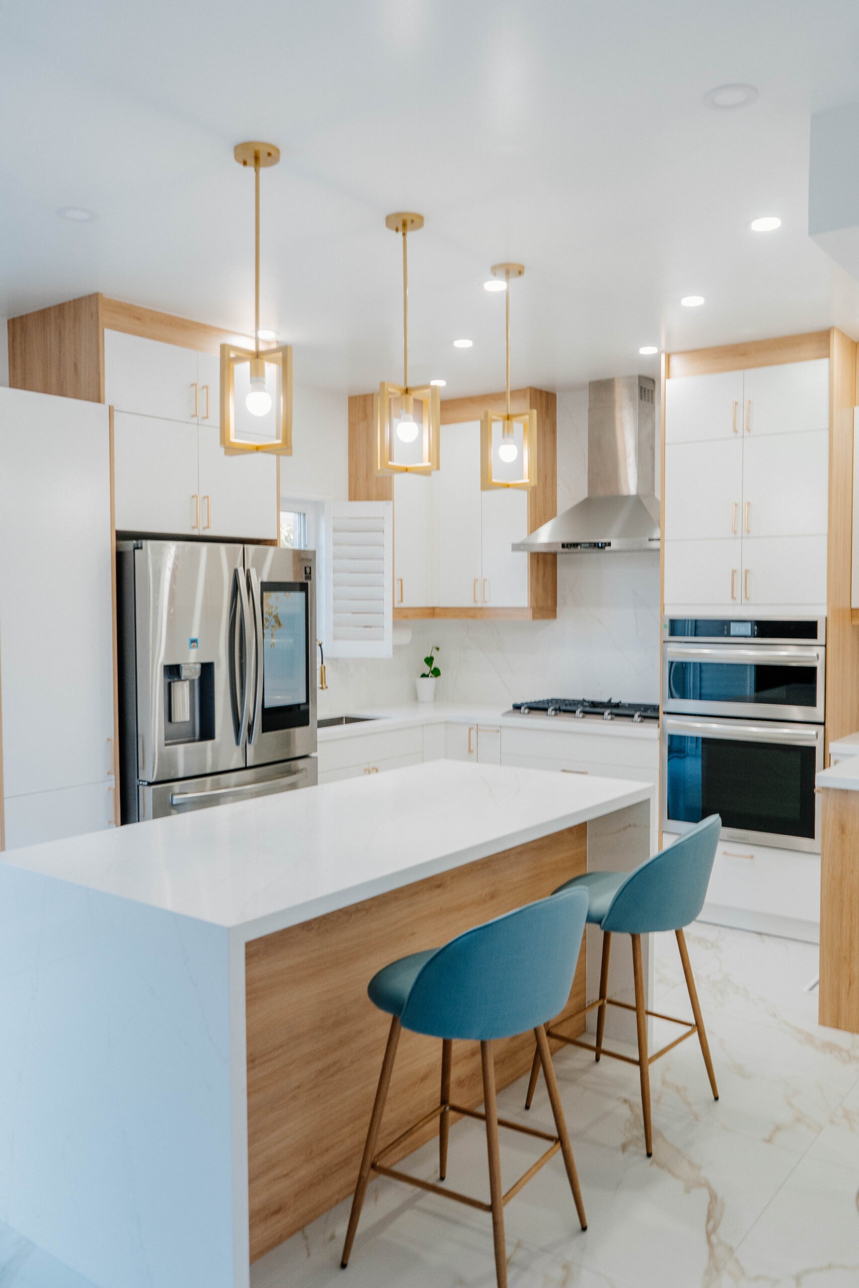 A bright, sweeping overview of the entire Deluxe Style kitchen renovation in Thornhill, highlighting the open concept layout and luxurious finishes