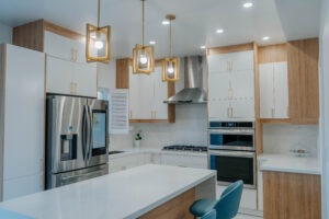 A complete overview of the Thornhill kitchen renovation, showing the harmonious layout of the two tone cabinets, quartz island, and modern gold lighting fixtures