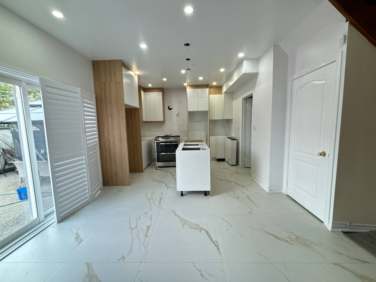 An expansive view of the open concept space during renovation, with the newly installed Deluxe Style kitchen cabinets awaiting final finishes Pickering