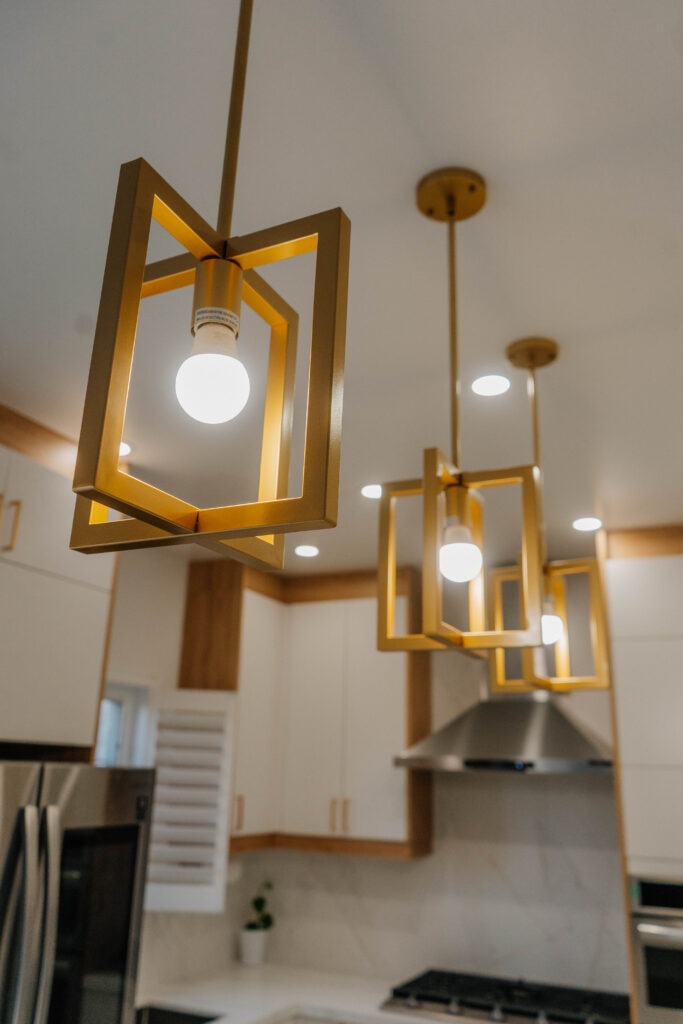 Artistic close up showcasing the design of the intersecting square gold pendant lights in the Thornhill Deluxe Style kitchen