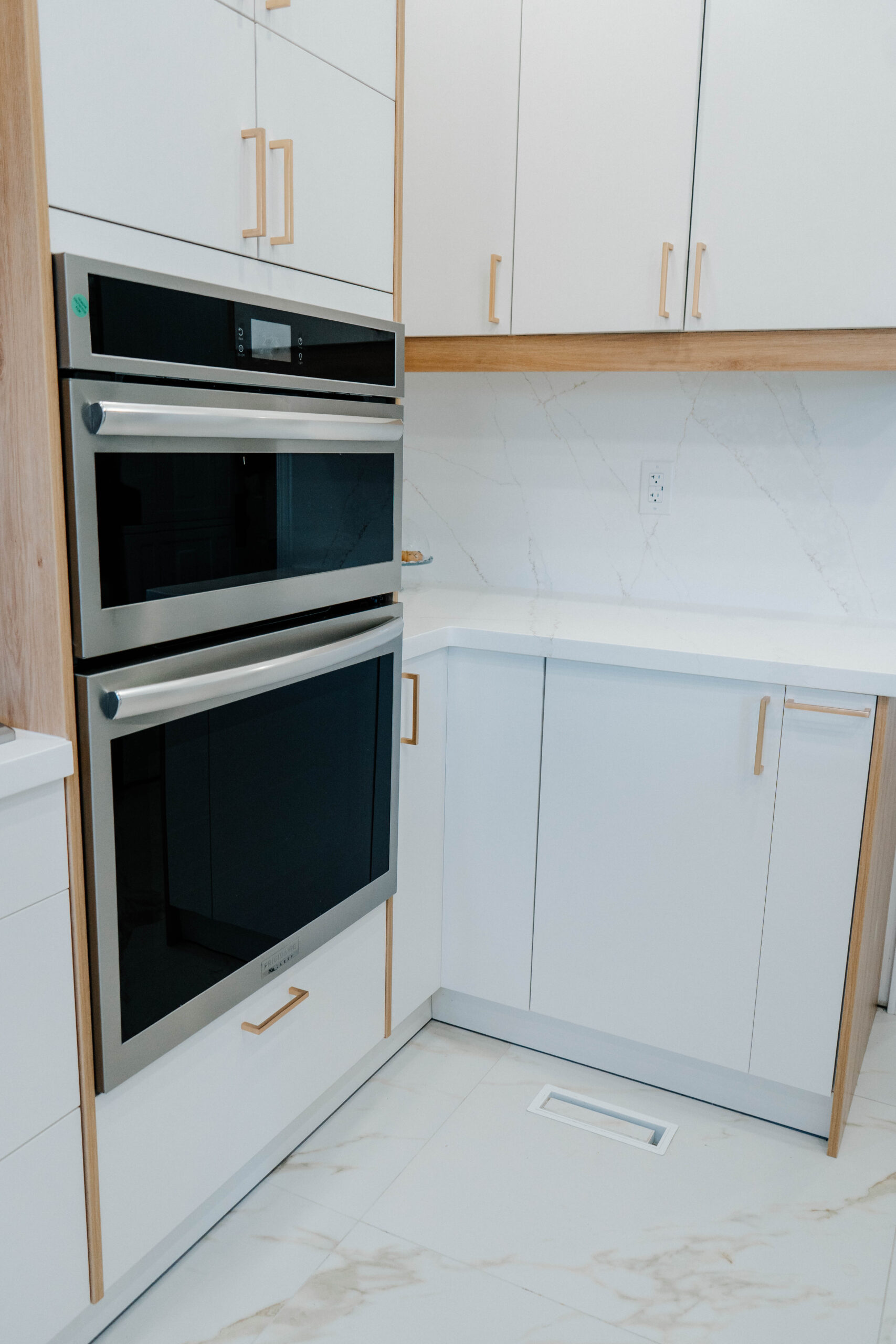 Corner detail of the Deluxe Style kitchen showing the stainless steel double wall oven integrated into the two tone cabinetry Pickering