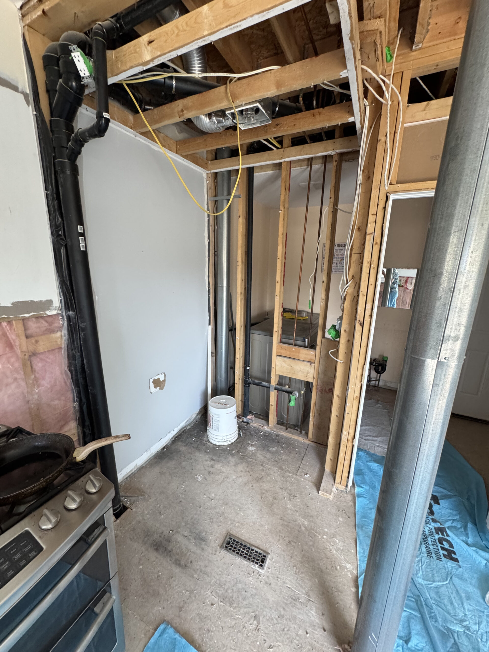 Exposed wall framing reveals the new plumbing HVAC and electrical work during the comprehensive Th Pickering