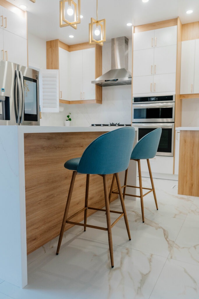 Kitchen Renovation Markham: Side profile of the two modern teal bar stools tucked into the Rustic Oak kitchen island, ready for casual dining