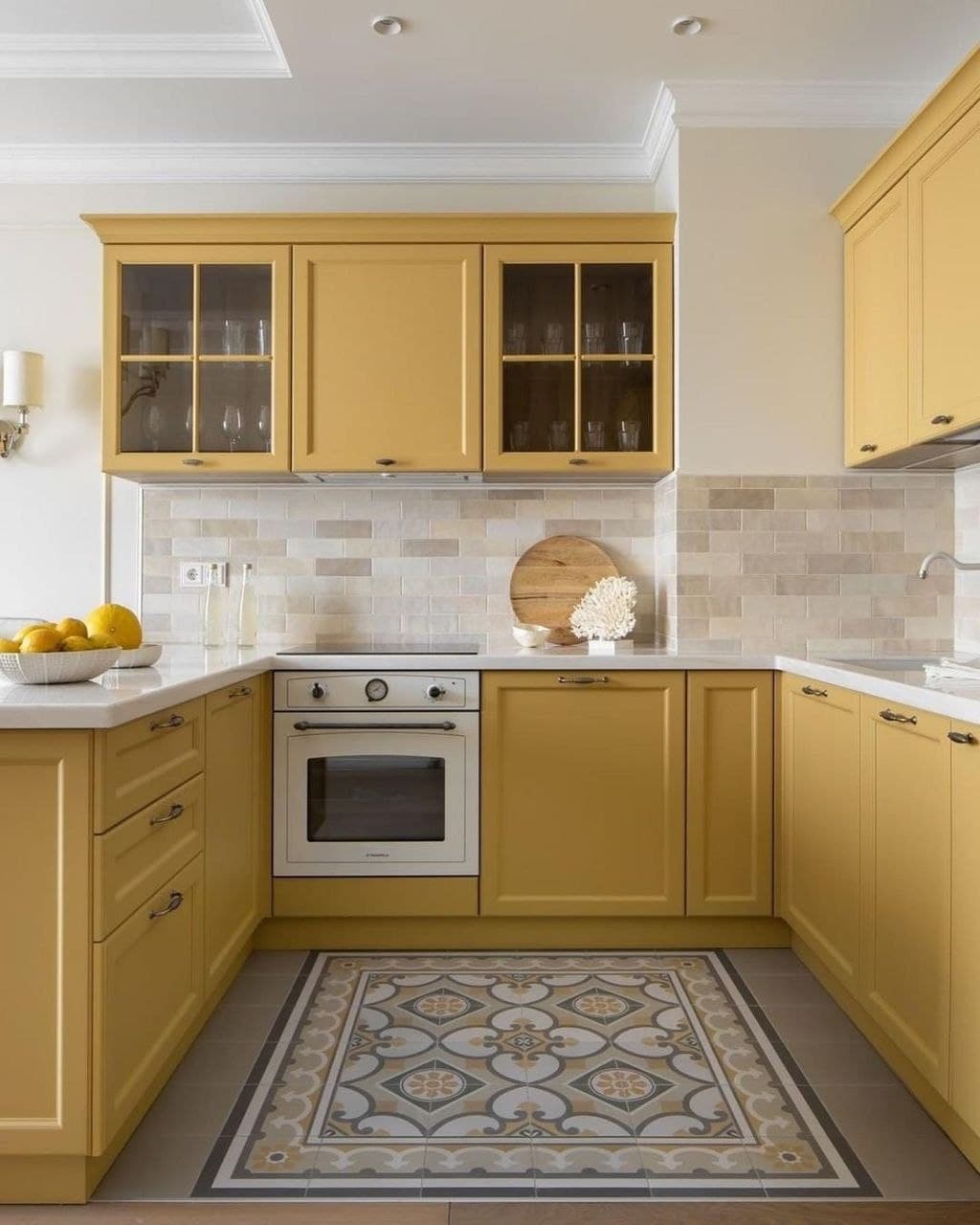 Sunny yellow farmhouse kitchen with white quartz countertops, integrated oven, and subway tile backsplash in a neutral tone Pickering