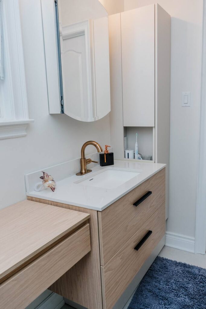 Custom floating wood tone vanity with side storage tower and mirrored medicine cabinet in Woodbridge luxury bathroom