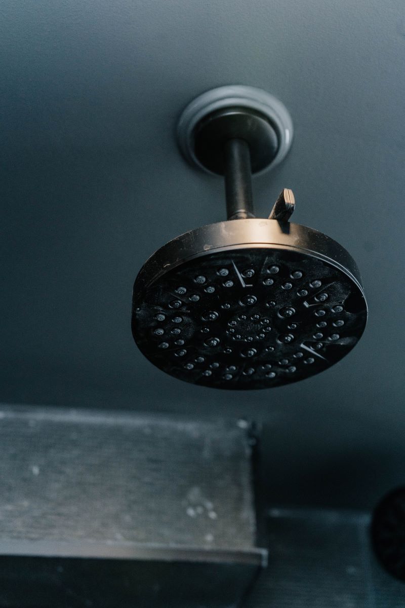 Ceiling mounted matte black rain shower head installed in a drop ceiling Barrie