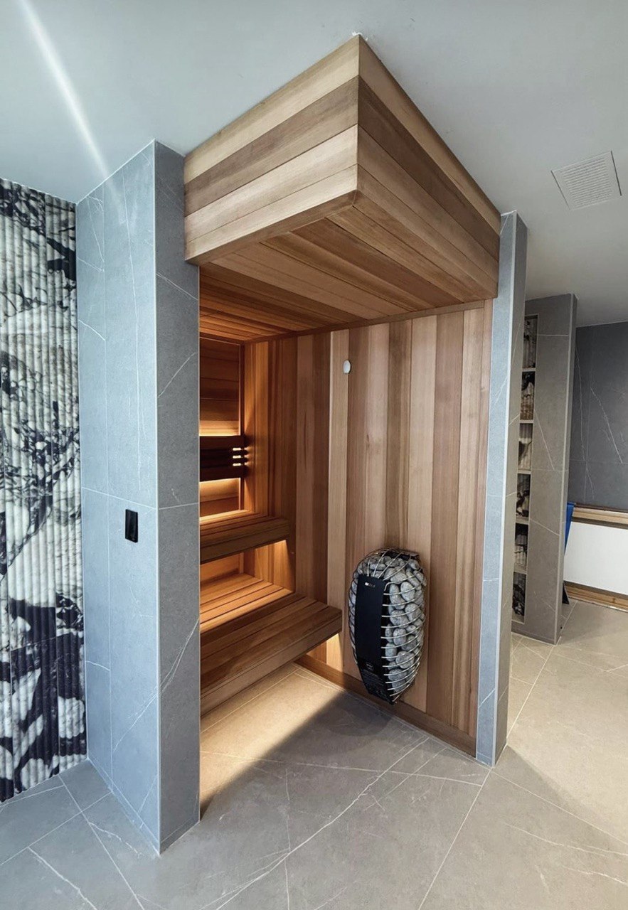 Custom built in sauna nook integrated into Toronto bathroom renovation with vertical wood paneling