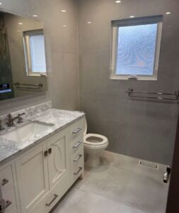 Elegant Powder room Renovation Heated Floors and High Tech Mirror
