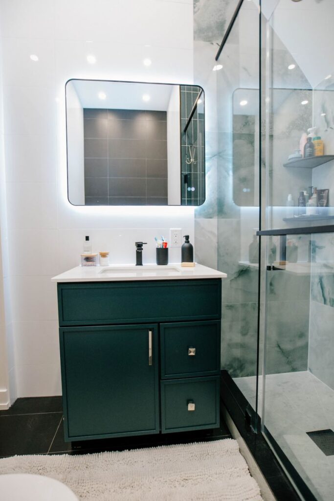 Front view of the new 30 inch deep green vanity cabinet with drawers and black hardware