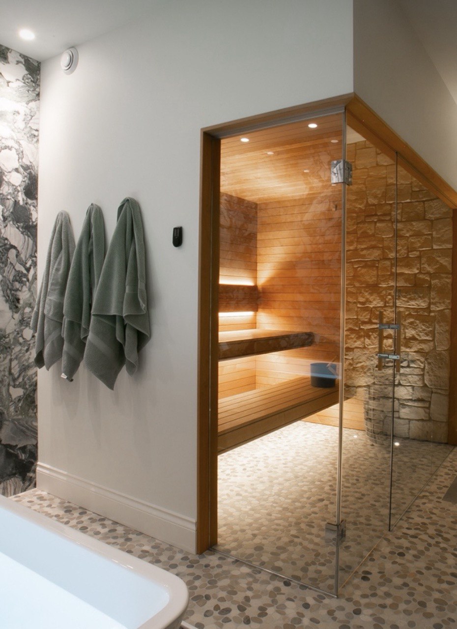 Modern residential sauna installation Toronto with stone accent wall under bench LED lighting