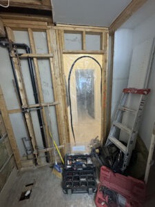 Rough in plumbing for steam shower installation Toronto showing vapor barrier preparation and framing