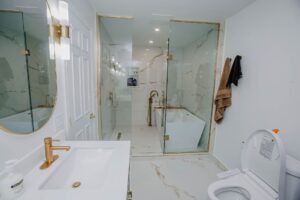 Master ensuite renovation with double vanity, toilet, glass shower and tub