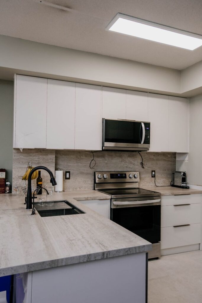 modern condo kitchen renovation in Toronto with white cabinets and peninsula