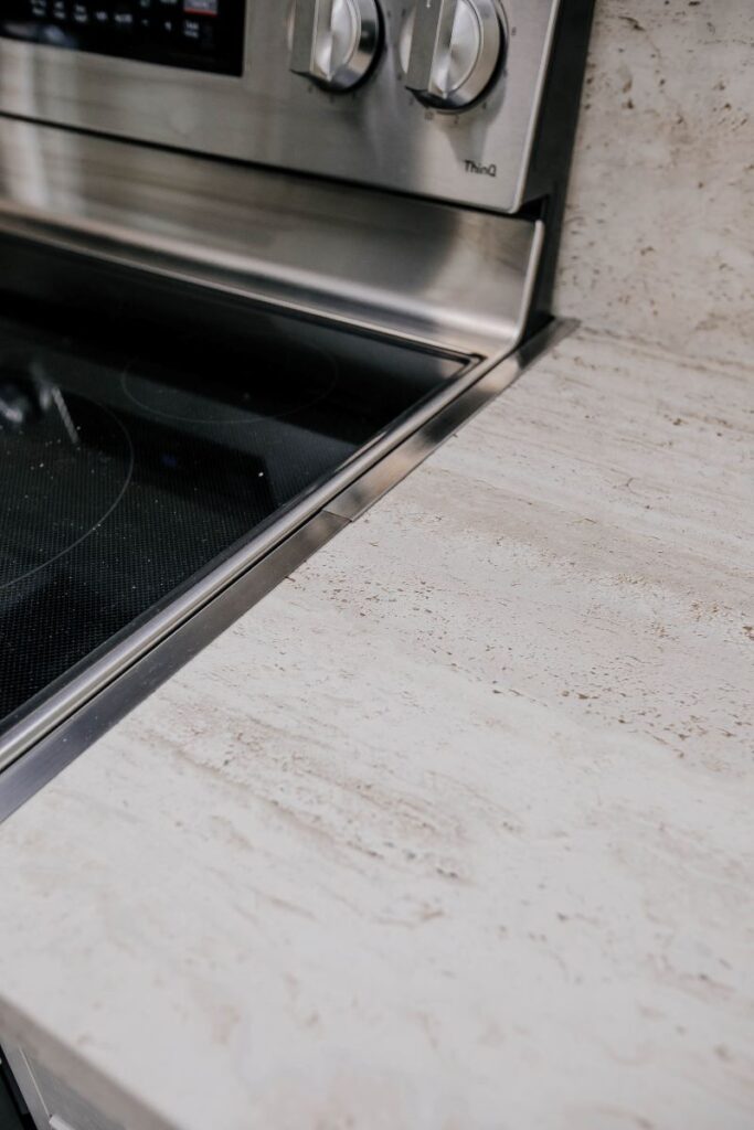 quartz countertop detail beside kitchen range in condo renovation