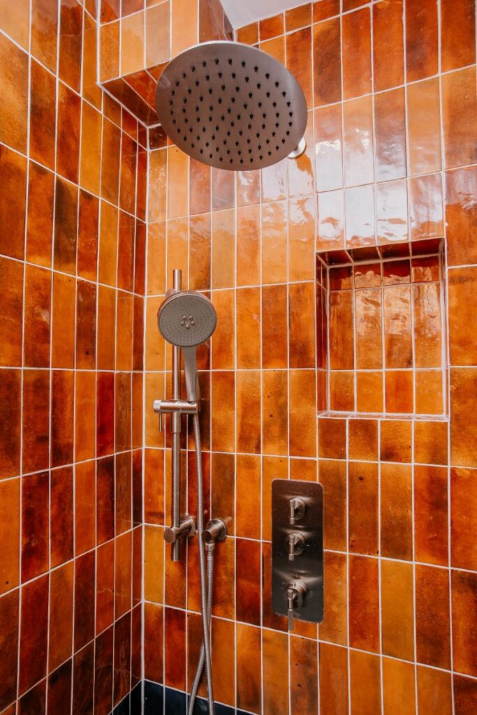 Curbless shower floor with linear drain and terrazzo look porcelain tile