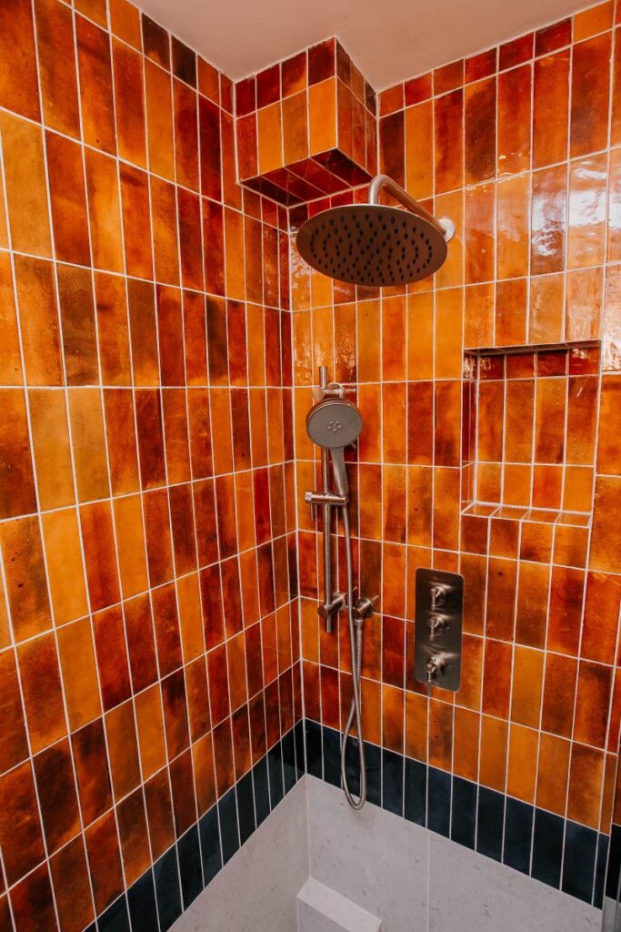 Finished bathroom remodel with sliding glass shower enclosure and floating vanity