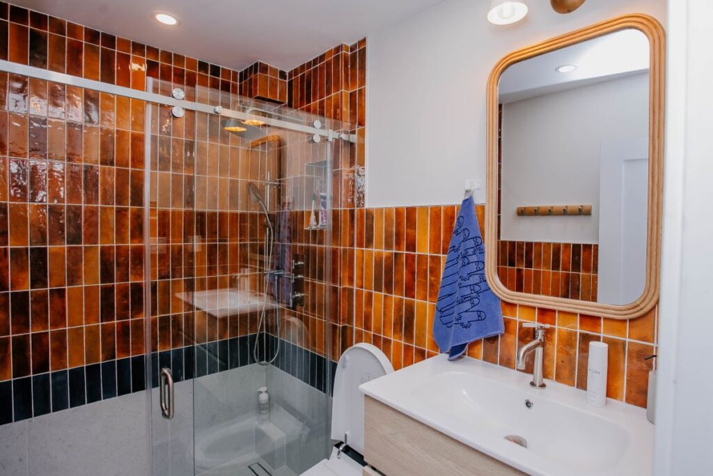 Modern shower system with rain head and handheld on rust toned glossy wall tile1