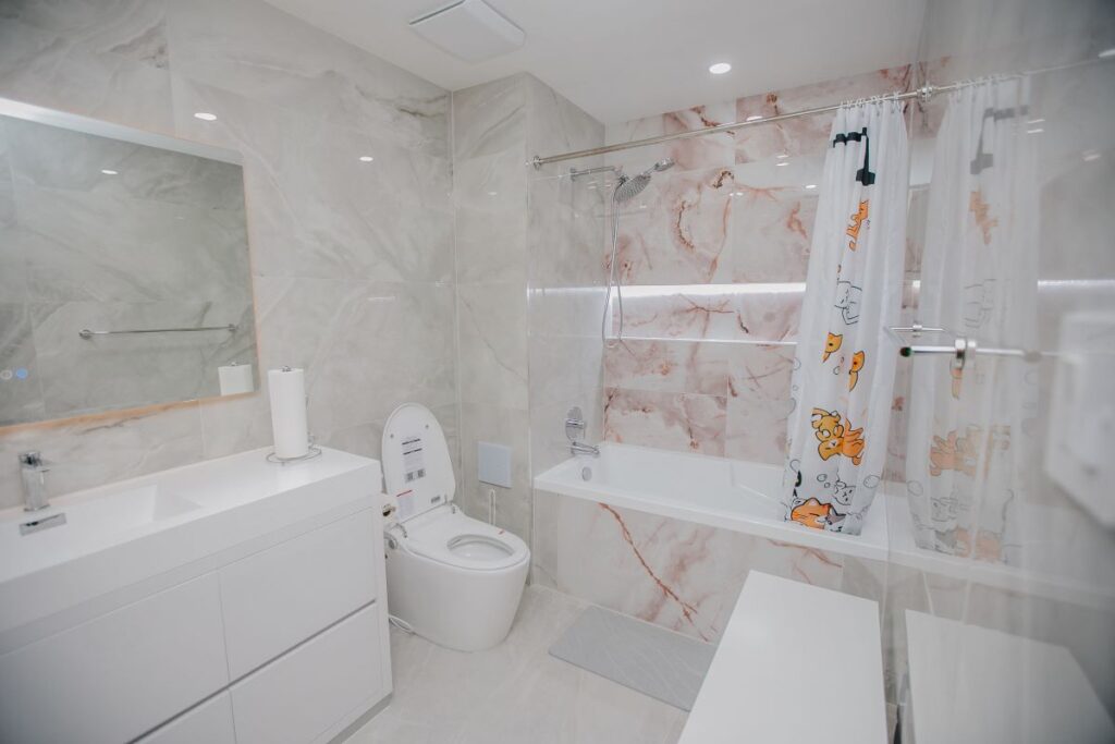 Completed spa style bathroom renovation with pearl marble and blush onyx tile