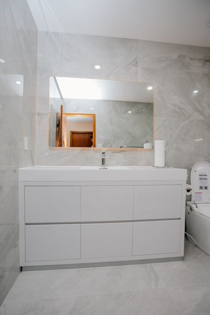 Floating white vanity with backlit LED mirror, bathroom renovation in North York