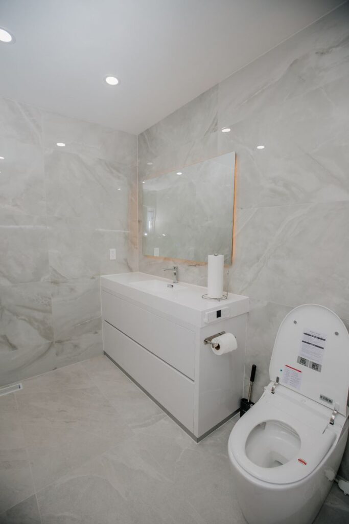 Full bathroom remodel with vanity, smart toilet and linear floor drain in York University Heights, North York