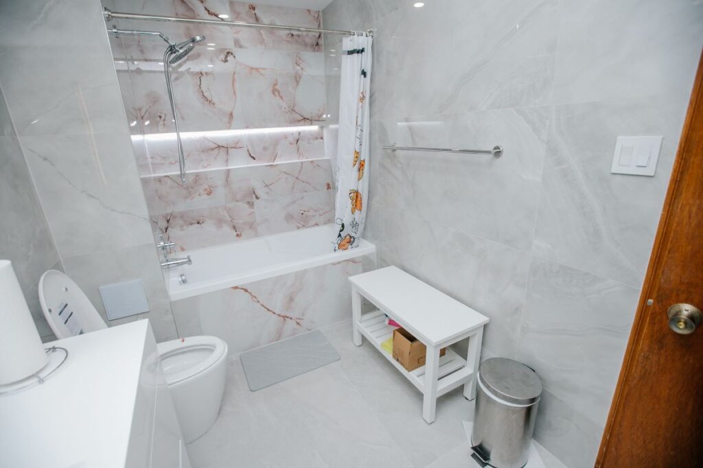 Full bathroom renovation with tub, smart toilet and bench in North York