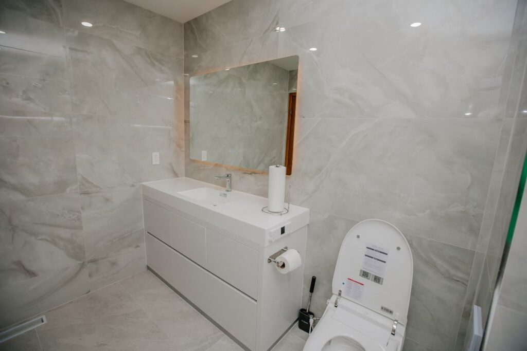 Modern grey marble bathroom with floating vanity and smart toilet in North York 2