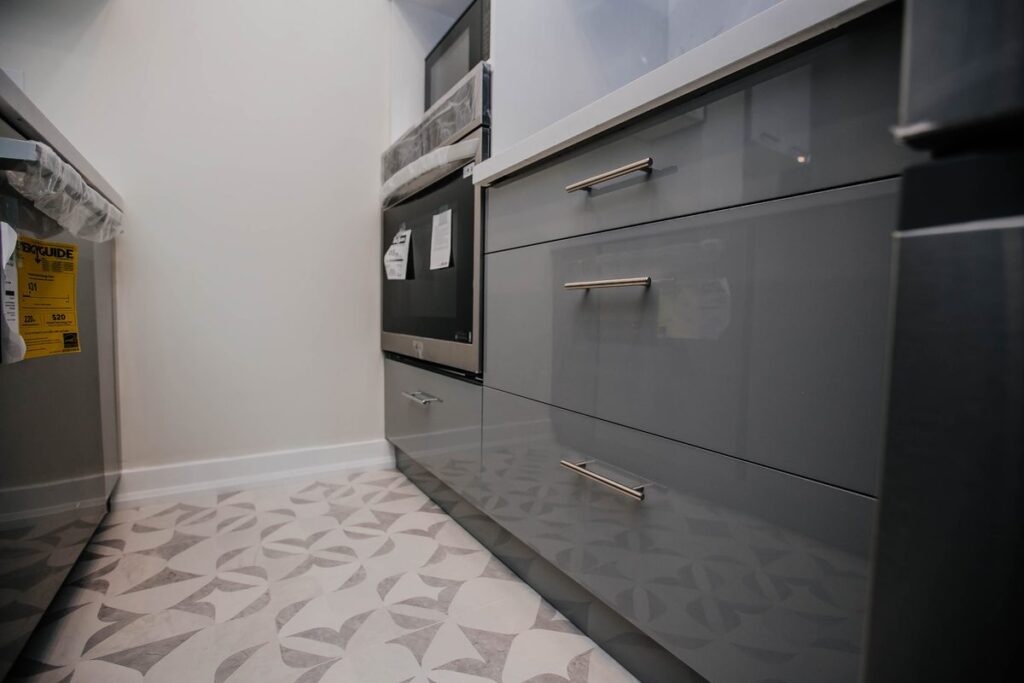 grey gloss drawer bank wall oven patterned floor scarborough condo kitchen