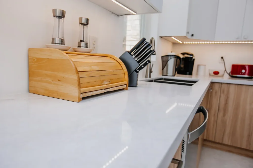 long countertop run with bread box and knife block in bright renovated kitchen of mississauga family home