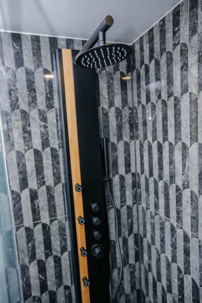 matte black rain shower head panel scallop tile scarborough condo bathroom