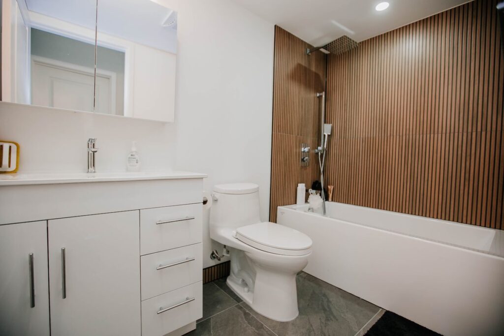 renovated condo bathroom slat tile tub white vanity scarborough toronto