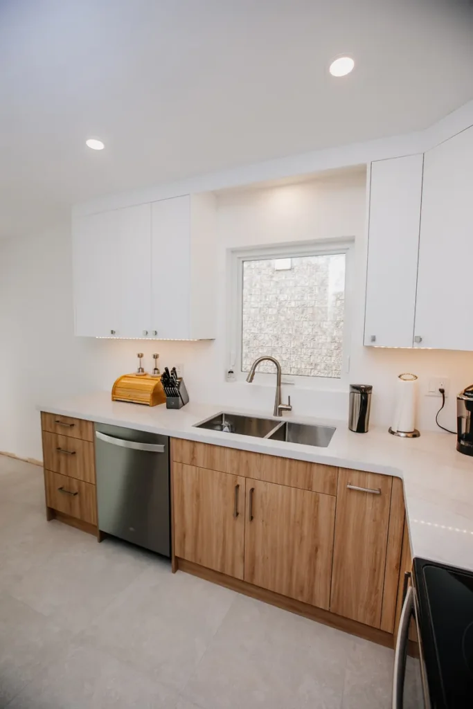 renovated mississauga kitchen sink wall with white ceiling height cabinets kraus sink and wood tone base cabinets