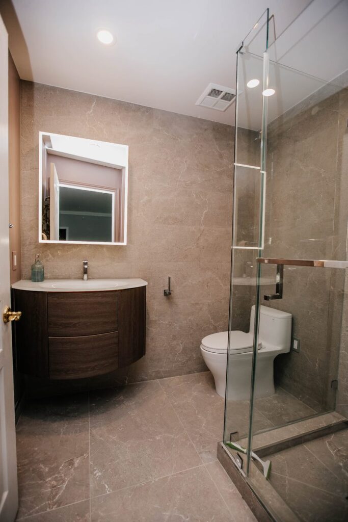 renovated woodbine condo bathroom oak vanity walk in glass shower toronto