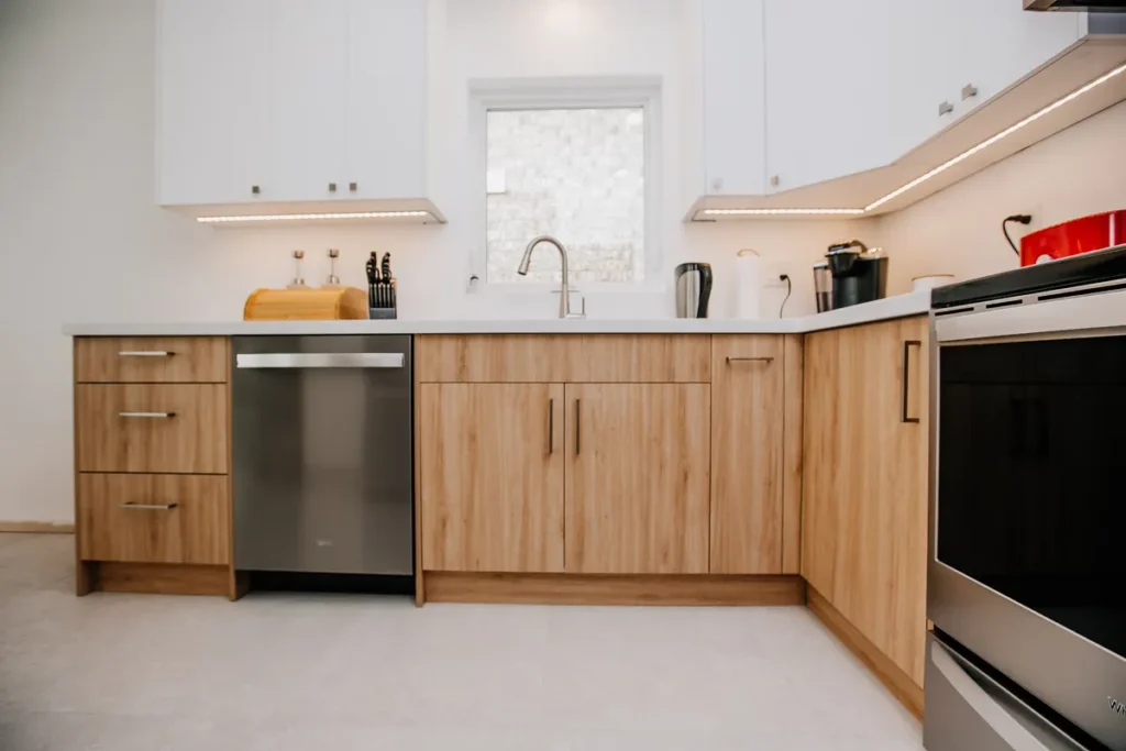 two tone kitchen renovation in mississauga with under cabinet led lighting and new porcelain floor tile by magic reno