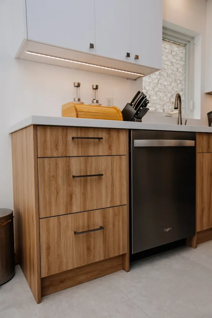 under cabinet led strip lighting above drawer stack and dishwasher in updated mississauga kitchen interior